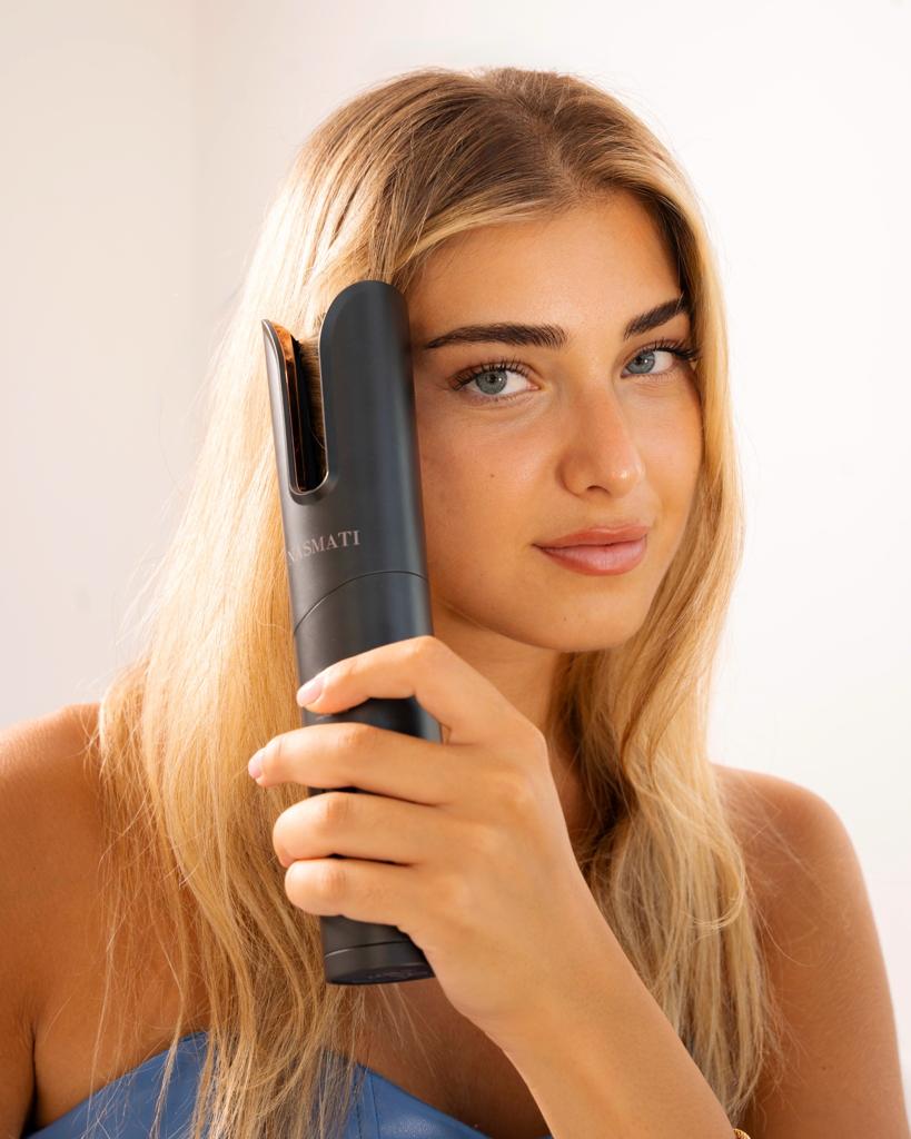 woman holding curling iron
